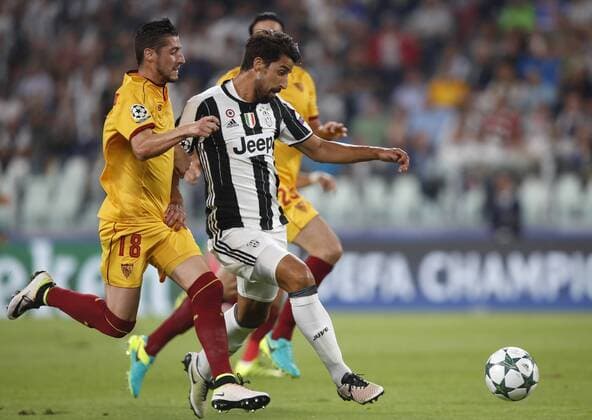 Italy Soccer Champions League: Juventus and Sevilla draw a scoreless tie JuventusÕ Sami Khedira, right, is tackled by Sevilla s Sergio Escudero during the Group H Champions League soccer match between Juventus and Sevilla at the Juventus Stadium. The game ended 0-0.  IsabellaxBonottox xPacificxPress