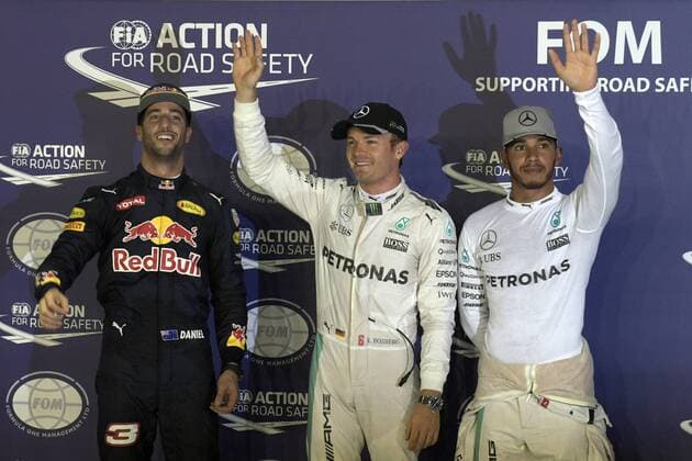 (160917) -- SINGAPORE, Sept. 17, 2016 -- Mercedes driver Nico Rosberg (C) of Germany celebrates his pole position as he stands next to Red Bull driver Daniel Ricciardo (L) of Australia and Mercedes driver Lewis Hamilton of Britain after the qualifying session on Day 2 of 2016 Singapore F1 Grand Prix Night Race, Sept. 17, 2016. ) (SP)SINGAPORE-F1-GRAND PRIX NIGHT RACE-POLE POSITION ThenxChihxWey 