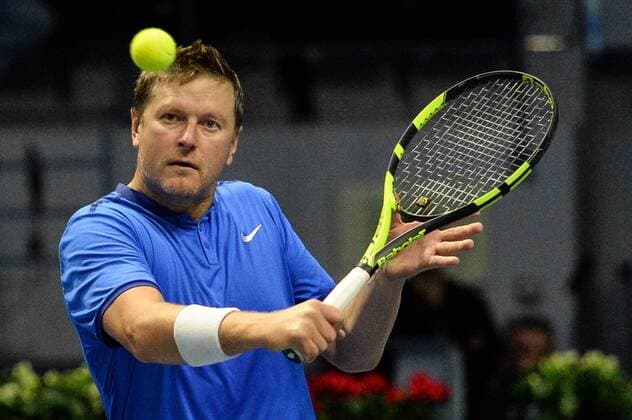 ST PETERSBURG, RUSSIA â€“ SEPTEMBER 25, 2016: Yevgeny Kafelnikov returns the ball in a mixed doubles match as part of the tennis legends show at the 2016 St. Petersburg Open. Andrei Ivanov TASS  TS032570