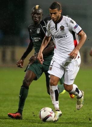 KRASNODAR, RUSSIA - SEPTEMBER 29, 2016: FC Krasnodar s Kouassi Eboue (L) and OGC Nice s Younes Belhanda struggle for the ball in the 2016 17 UEFA Europe League Group I Round 2 football match at the Kuban Stadium. Krasnodar won the game 5-2. Vitaly Timkiv TASS  TS032CD9