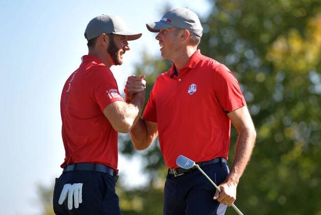 USA team member Dustin Johnson (L) celebrates with teammate Matt Kuchar after the two won their match during the first day of the 2016 Ryder Cup at Hazeltine National Golf Club in Chaska, Minnesota on September 30, 2016.  MIN20160930301 KEVINxDIETSCH