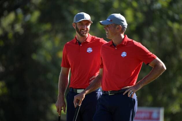 USA team member Dustin Johnson (L) and Matt Kuchar stand together on the 13th hole during day 1 of the 2016 Ryder Cup at Hazeltine National Golf Club in Chaska, Minnesota on September 30, 2016.  MIN20160930305 KEVINxDIETSCH