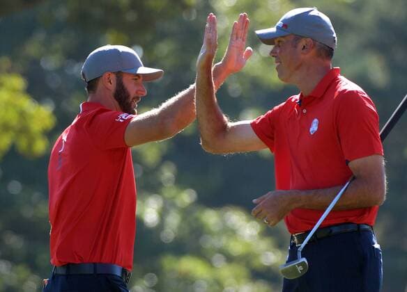USA team member Dustin Johnson (L) and Matt Kuchar celebrate after winning the 13th hole during day 1 of the 2016 Ryder Cup at Hazeltine National Golf Club in Chaska, Minnesota on September 30, 2016.  MIN20160930308 KEVINxDIETSCH