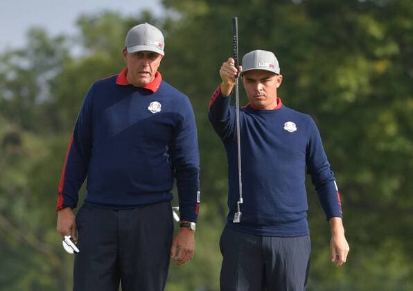 USA team member Phil Mickelson (L) and Rickie Fowler line up a putt on the 10th green during day 1 of the 2016 Ryder Cup at Hazeltine National Golf Club in Chaska, Minnesota on September 30, 2016.  MIN20160930336 KEVINxDIETSCH