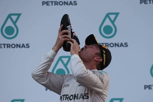 Malaysian Grand Prix, Sepang 29 September - 2 October 2016 02.10.2016 - Race, 3rd position Nico Rosberg (GER) Mercedes AMG F1 W07 Hybrid drinks champagne with the shoe of Daniel Ricciardo (AUS) Red Bull Racing RB12 
