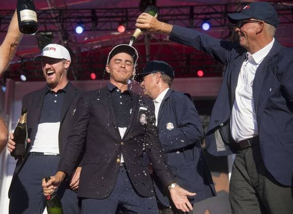 USA team vice captain Tom Lehman pours champions on Rickie Fowler after the United States defeated Europe 17-11 to win the 2016 Ryder Cup at Hazeltine National Golf Club in Chaska, Minnesota on October 2, 2016. USA defeated Europe for the first time since 2008.  MIN20161002342 KEVINxDIETSCH
