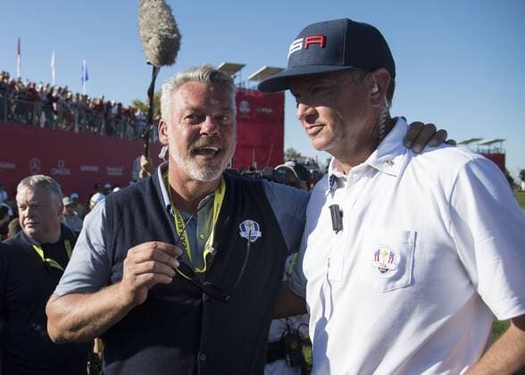 USA team captain Davis Love III (R) embraces European team captain Darren Clarke after the United States defeated Europe to win the 2016 Ryder Cup at Hazeltine National Golf Club in Chaska, Minnesota on October 2, 2016. USA defeated Europe 17-11 winning the Ryder Cup for the first time since 2008.  MIN20161002366 KEVINxDIETSCH
