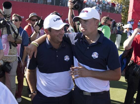 USA team members Jordan Spieth (R) hugs Patrick Reed after defeating Europe to win the 2016 Ryder Cup at Hazeltine National Golf Club in Chaska, Minnesota on October 2, 2016. USA defeated Europe 17-11 winning the Ryder Cup for the first time since 2008.  MIN20161002367 KEVINxDIETSCH