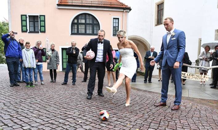 Fussball, Herren, Saison 2016 17, 1. FC Union Berlin, Standesamtliche Hochzeit von Toni Leistner (1. FC Union) und Josefin in Oschatz (Sachsen), Toni (r.) und Josefin schnitten Herzen aus einem Fußballfeld, im Anschluss gab es ein Torwandschießen, links Fred (Bruder von Josefin), 08.10. 2016,