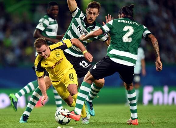 LISBON, Oct. 18, 2016 -- Sporting s Ezequiel Schelotto (R) vies with Dortmund s Mario Gotze (L) during the UEFA Champions League football match between Sporting CP and BVB Borussia Dortmund in Lisbon, Portugal, Oct. 18, 2016. Sporting lost 1-2. ) (SP)PORTUGAL-LISBON-FOOTBALL-UEFA CHAMPIONS LEAGUE ZhangxLiyun 