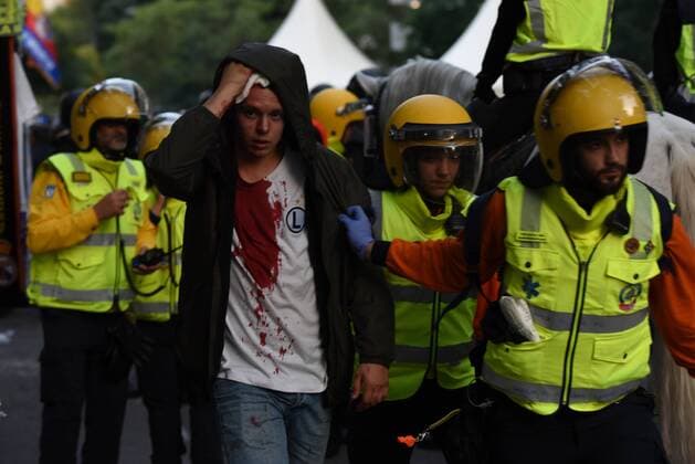 Fußball, CL, Real Madrid - Legia Warschau, Ausschreitungen vor dem Spiel Spanish riot police charge Legia fans in Madrid Members of the specialized emergency system in Madrid help a wounded Legia fan during clashes with Spanish riot police in Madrid.  JorgexSanzx xPacificxPress