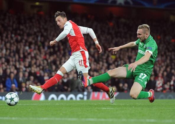 Football - 2016 2016 Champions League - Arsenal vs. PFC Ludogorets Razgrad Mesut Ozil of Arsenal scores the first goal of his hat trick at The Emirates. COLORSPORT ANDREW COWIE 