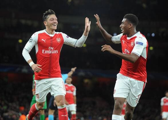 Football - 2016 2016 Champions League - Arsenal vs. PFC Ludogorets Razgrad Mesut Ozil of Arsenal celebrates the third goal of his hat trick with Alex Iwobi at The Emirates. COLORSPORT ANDREW COWIE 