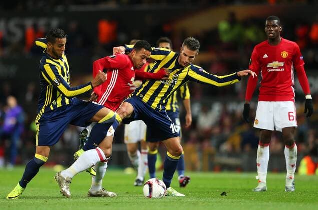 Robin van Persie of Fenerbahce tackles Memphis Depay of Manchester United ManU during the UEFA Europa League match at Old Trafford, Manchester. Picture date: October 20th, 2016. Pic Matt McNulty Sportimage EDITORIAL USE ONLY. No use with unauthorised audio, video, data, fixture lists, club league logos or live services. Online in-match use limited to 120 images, no video emulation. No use in betting, games or single club league player publications.
