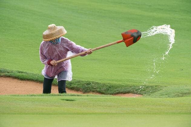 October 23, 2016 - Haikou, Hainan, China - The course maintenance team come out after the rain stops. Heavy rain stops play on the Blackstone course in Mission Hills resort Haikou during the 2nd round of the 4th World celebrity Pro-am. .Blackstone course, Mission Hills resort, Haikou, Hainan Island China. Round 2 of the Mission Hills 4th World celebrity Pro-Am tournament 2016 - ZUMAr144 20161023_zap_r144_049