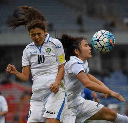 (161024) -- CHONGQING, Oct. 24, 2016 -- Zumratjon Nazarova (L) and Makhliyo Yusupova of Uzbekistan collide during a match against Iceland at Sincere International Women s Football Tournament Yongchuan 2016 in Chongqing, southwest China, Oct. 24, 2016. Iceland won 1-0. ) (SP)CHINA-CHONGQING-SOCCER-SINCERE YONGCHUAN 2016 ChenxCheng 