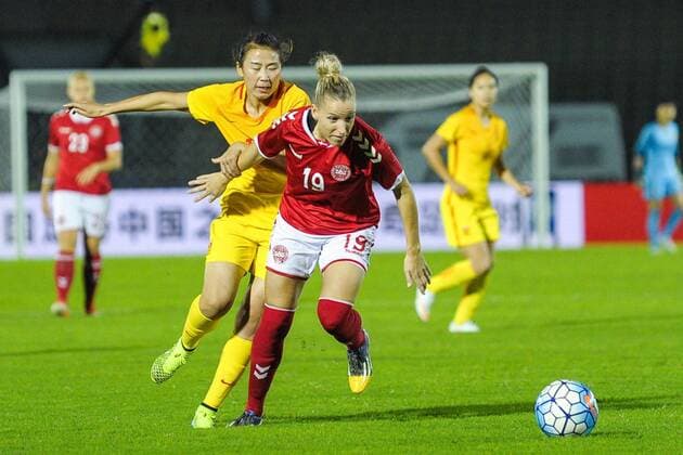 Yang Li of China, left, challenges Cecilie Sandvej of Denmark in a match during the CFA International Women s Football Tournament Yongchuan 2016 in Chongqing, China, 24 October 2016. China defeated Denmark 1-0. China edges out Denmark at women s football tournament in Chongqing  20161024_14863