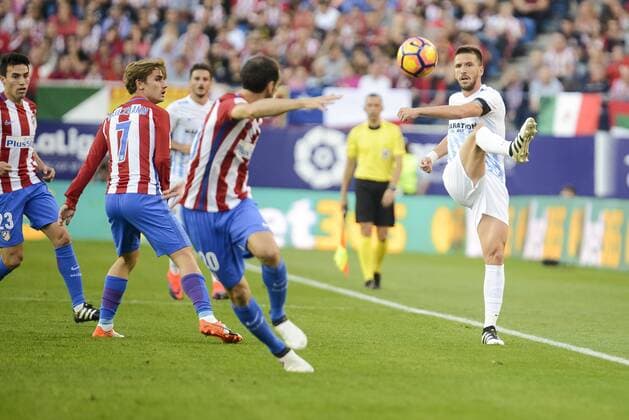 Atletico de Madrid s player Antoine Griezmann and Diego Godín and Malaga CF Ignacio Camacho during a match of La Liga Santander at Vicente Calderon Stadium in Madrid. October 29, Spain. 2016.  (20161029009)