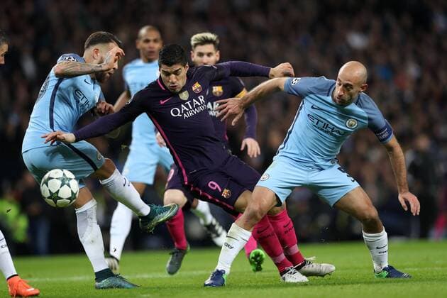 Football - 2016 2017 UEFA Champions League - Group C: Manchester City vs. Barcelona Nicolas Otamendi and Pablo Zabaleta of Manchester City stop Luis Suarez of Barcelona during the match at The Etihad Stadium. COLORSPORT LYNNE CAMERON 