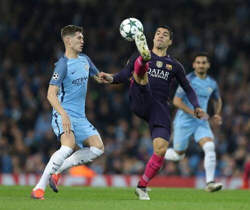 John Stones of Manchester City and Luis Suarez of Barcelona during the Champions League Group C match at the Etihad Stadium, Manchester. Picture date: November 1st, 2016. Pic Simon Bellis Sportimage EDITORIAL USE ONLY. No use with unauthorised audio, video, data, fixture lists, club league logos or live services. Online in-match use limited to 120 images, no video emulation. No use in betting, games or single club league player publications.