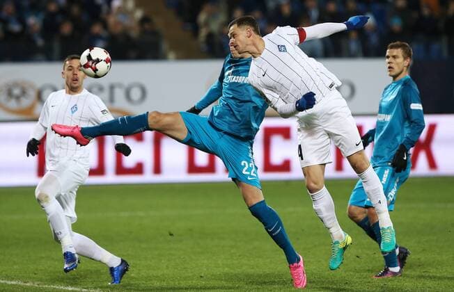 ST PETERSBURG, RUSSIA - NOVEMBER 20, 2016: Zenit St Petersburg s Artyom Dzyuba and Krylya Sovetov Samara s Ivan Taranov (L-R center) fight for the ball in their 2016-17 Season Russian Premier League Round 14 football match at the Petrovsky Stadium. Peter Kovalev TASS  TS0383C1