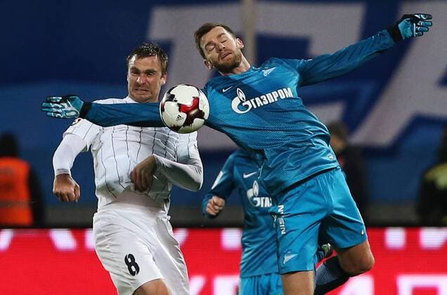 ST PETERSBURG, RUSSIA - NOVEMBER 20, 2016: Krylya Sovetov Samara s Sergei Kornilenko (L) and Zenit St Petersburg s Nicolas Lombaerts fight for the ball in their 2016-17 Season Russian Premier League Round 14 football match at the Petrovsky Stadium. Peter Kovalev TASS  TS0383C8