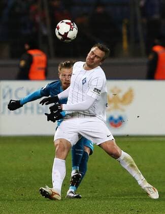 ST PETERSBURG, RUSSIA - NOVEMBER 20, 2016: Zenit St Petersburg s Ivan Novoseltsev (L) and Krylya Sovetov Samara s Sergei Kornilenko fight for the ball in their 2016-17 Season Russian Premier League Round 14 football match at the Petrovsky Stadium. FC Zenit St Petersburg won the game 3-1. Peter Kovalev TASS  TS038409