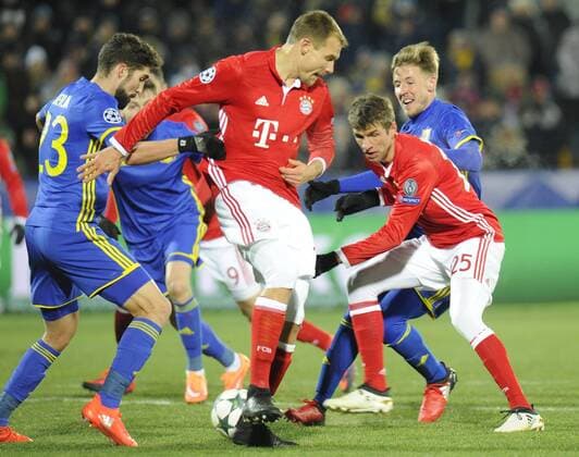 ROSTOV-ON-DON, RUSSIA - NOVEMBER 23, 2016: FC Rostov s Miha Mevlja (L), FC Bayern Munich s Holger Badstuber and Thomas Muller (L-R in red) struggle for the ball in their 2016 17 UEFA Champions League Group D Round 5 football match at the Olimp-2 Stadium. Rostov won the game 3-2. Valery Matytsin TASS  TS0389D0