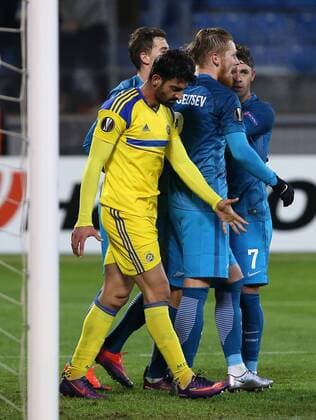ST PETERSBURG, RUSSIA â€“ NOVEMBER 24, 2016: Maccabi Tel-Avivâ€™s Omri Ben Harush (L front), and Zenit St Petersburgâ€™s Ivan Novoseltsev (C) and Giuliano de Paula (R) in their 2016 2017 UEFA Europa League Round 5 Group D football match at Petrovsky Stadium. Zenit St Petersburg won 2-0. Peter Kovalev TASS  TS038BED
