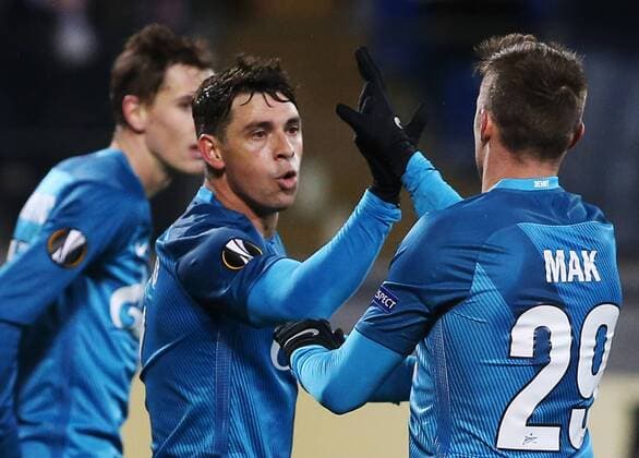 ST PETERSBURG, RUSSIA â€“ NOVEMBER 24, 2016: Zenit St Petersburgâ€™s Giuliano de Paula (C) and Robert Mak (R) celebrate a goal against Maccabi Tel-Aviv in their 2016 2017 UEFA Europa League Round 5 Group D football match at Petrovsky Stadium. Zenit St Petersburg won 2-0. Peter Kovalev TASS  TS038BB6