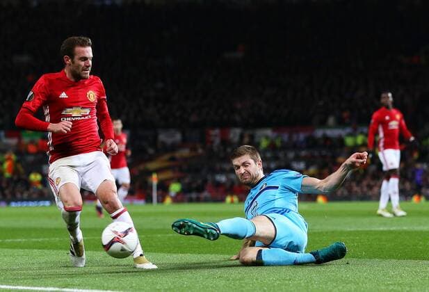 Marko Vejinovic of Feyenoord clears the ball under pressure from Juan Mata of Manchester United ManU during the UEFA Europa League match at Old Trafford, Manchester. Picture date: November 24th 2016. Pic Matt McNulty Sportimage EDITORIAL USE ONLY. No use with unauthorised audio, video, data, fixture lists, club league logos or live services. Online in-match use limited to 120 images, no video emulation. No use in betting, games or single club league player publications.