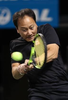 November 26, 2016, Tokyo, Japan - Former French Opens Tennis champion Michael Chang of the United States returns the ball against Japan s Taro Daniel during an annual charity tennis match Dream Tennis Ariake in Tokyo on Saturday, November 26, 2016. Admission money will be donated for the rebuild of tennis facilities at the tsunami affected area in northern Japan. NOxTHIRDxPARTYxSALES.  (lwxa006486)