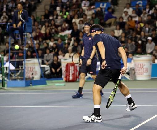 November 26, 2016, Tokyo, Japan - Japan s Kei Nishikori and his coach former French Opens Tennis champion Michael Chang of the United States pair return the ball against Andy Roddick of the United States and Japan s Taro Daniel during an annual charity tennis match Dream Tennis Ariake in Tokyo on Saturday, November 26, 2016. Admission money will be donated for the rebuild of tennis facilities at the tsunami affected area in northern Japan. NOxTHIRDxPARTYxSALES.  (lwxa006498)