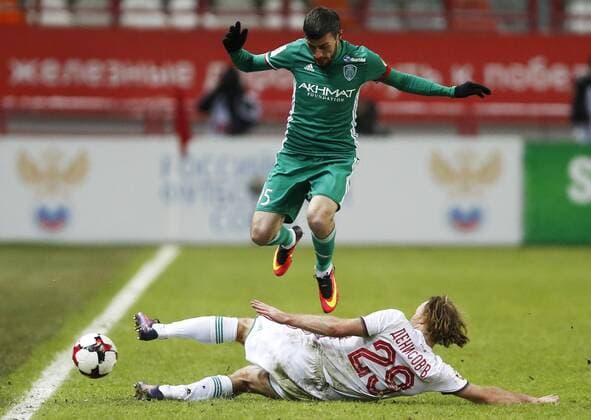 MOSCOW, RUSSIA - DECEMBER 4, 2016: Lokomotiv Moscow s Vitaly Denisov (white) and Terek Grozny s Magomed Mitrishev fight for the ball in their 2016 17 Russian Premier League Round 17 football match at Lokomotiv Stadium. Mikhail Japaridze TASS  TS039E2B