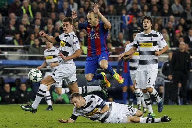 BARCELONA, Dec. 6, 2016 -- Barcelona s Andres Iniesta (C) jumps over Borussia Monchengladbach s Tony Jantschke during the UEFA Champions League match at Camp Nou stadium in Barcelona, Spain, Dec. 6, 2016. Barcelona won 4-0. ) (SP)SPAIN-BARCELONA-SOCCER-BARCELONA VS BORUSSIA MONCHENGLADBACH PauxBarrena 