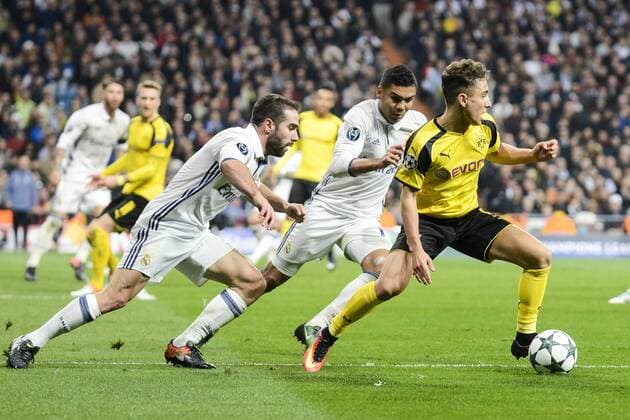 Real Madrid s Daniel Carvajal and Carlos Henrique Casemiro and Borussia Dortmund Emre Mor during the UEFA Champions League match between Real Madrid and Borussia Dortmund at Santiago Bernabeu Stadium in Madrid, Spain. December 07, 2016.  (20161207043)
