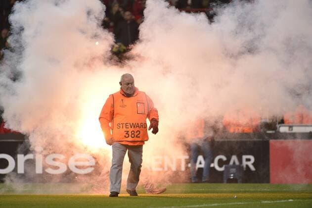 Illustration picture shows a steward surrounded by fireworks during the sixth and last game of the group stage (group G) of the Europa League competition between Belgian soccer team Standard de Liege and Dutch club Ajax Amsterdam in Liege, Thursday 08 December 2016. NICOLASxLAMBERT  x04994161x