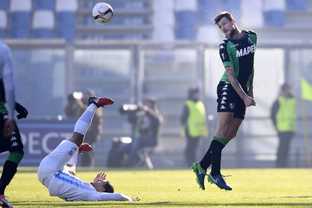 Genk s Nikolaos Karelis and Sassuolo s Francesco Acerbi fight for the ball during a soccer game between Italian Club U.S. Sassuolo Calcio and Belgian team KRC Genk in Parma, Italy, Friday 09 December 2016, the sixth and last game of the group stage of the Europa League competition, in Group F. The match was scheduled for yesterday, but it was postponed due to heavy fog. YORICKxJANSENS  x04994456x