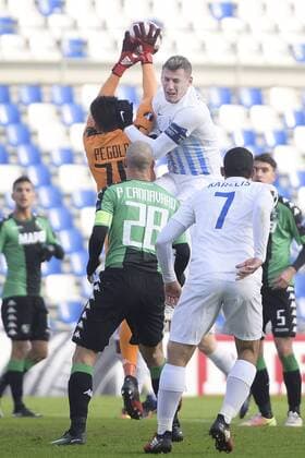 Sassuolo s goalkeeper Gianluca Pegolo and Genk s Sebastien Dewaest fight for the ball during a soccer game between Italian Club U.S. Sassuolo Calcio and Belgian team KRC Genk in Parma, Italy, Friday 09 December 2016, the sixth and last game of the group stage of the Europa League competition, in Group F. The match was scheduled for yesterday, but it was postponed due to heavy fog. YORICKxJANSENS  x04994531x