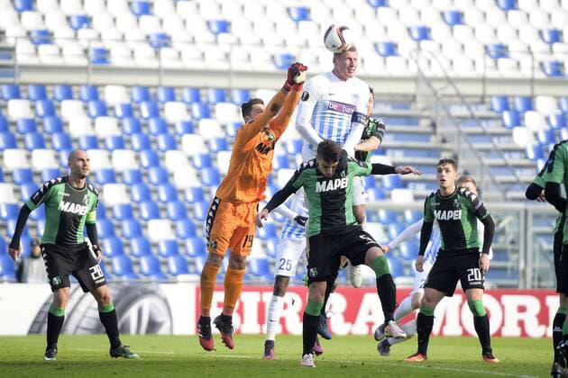 Sassuolo s goalkeeper Gianluca Pegolo and Genk s Sebastien Dewaest fight for the ball during a soccer game between Italian Club U.S. Sassuolo Calcio and Belgian team KRC Genk in Parma, Italy, Friday 09 December 2016, the sixth and last game of the group stage of the Europa League competition, in Group F. The match was scheduled for yesterday, but it was postponed due to heavy fog. YORICKxJANSENS  x04994534x
