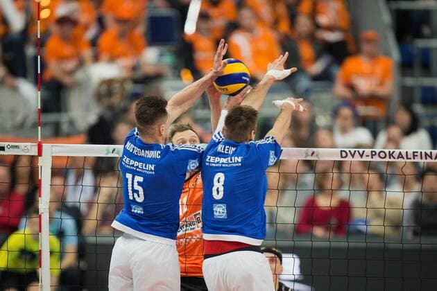 Mannheim, Deutschland, 29.01.2017: Volleyball DVV Pokal Saison 2016 2017 - DVV Pokalfinale - VfB Friedrichshafen - BR Volleys. Paul Carroll (BR Volleys 12) gegen den Block aus Armin Mustedanovic (Friedrichshafen 15) uGeorg Klein (Friedrichshafen 8)