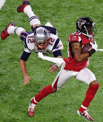 New England Patriots quarterback Tom Brady dives and misses tackling Atlanta Falcons cornerback Robert Alford who returns an interception 82-yards for a touchdown during the second quarter at Super Bowl LI at NRG Stadium in Houston, Texas on February 5, 2017.  SBP2017020529 DAVIDxTULIS