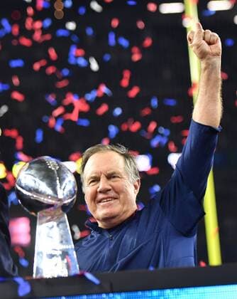 New England Patriots head coach Bill Belichick raises a fist behind the Vince Lombardi Trophy after the Patriots defeated the Atlanta Falcons in Super Bowl LI at NRG Stadium in Houston on February 5, 2017. The Patriots came from behind to defeat the Falcons 34-28 in overtime.  SBP20170205502 KEVINxDIETSCH