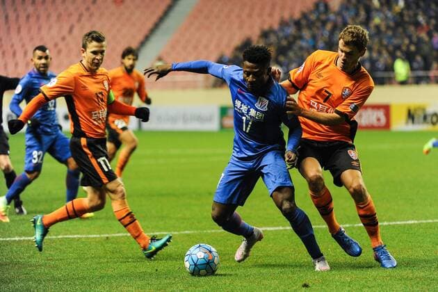 Obafemi Martins of China s Shanghai Greenland Shenhua F.C., center, challenges players of Australia s Brisbane Roar F.C. in a qualifying match during the 2017 AFC Champions League in Shanghai, China, 8 February 2017. Carlos Tevez s debut for big-spending Chinese Super League side Shanghai Shenhua did not go as planned. In fact, it was the exact opposite as they were unceremoniously dumped out of the Asian Champions League play-off by Brisbane Road. Tevez, who moved to China from Boca Juniors for a reported ¡ê615,000-a-week and became the world s highest-paid player , couldn t help his new team-mates as they went down 2-0 in one of the biggest shocks the AFC has seen. Carlos Tevez has nightmare debut for Shanghai Shenhua as they are dumped out of AFC Champions League  20170208_35536