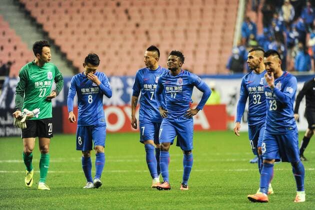 Players of China s Shanghai Greenland Shenhua F.C., react after being defeated by Australia s Brisbane Roar F.C. in a qualifying match during the 2017 AFC Champions League in Shanghai, China, 8 February 2017. Carlos Tevez s debut for big-spending Chinese Super League side Shanghai Shenhua did not go as planned. In fact, it was the exact opposite as they were unceremoniously dumped out of the Asian Champions League play-off by Brisbane Road. Tevez, who moved to China from Boca Juniors for a reported ¡ê615,000-a-week and became the world s highest-paid player , couldn t help his new team-mates as they went down 2-0 in one of the biggest shocks the AFC has seen. Carlos Tevez has nightmare debut for Shanghai Shenhua as they are dumped out of AFC Champions League  20170208_13336