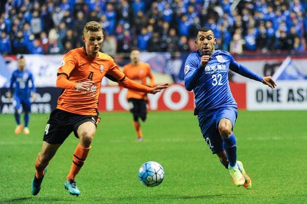 Argentine football player Carlos Tevez of China s Shanghai Greenland Shenhua F.C., right, challenges Daniel Bowles of Australia s Brisbane Roar F.C. in a qualifying match during the 2017 AFC Champions League in Shanghai, China, 8 February 2017. Carlos Tevez s debut for big-spending Chinese Super League side Shanghai Shenhua did not go as planned. In fact, it was the exact opposite as they were unceremoniously dumped out of the Asian Champions League play-off by Brisbane Road. Tevez, who moved to China from Boca Juniors for a reported ¡ê615,000-a-week and became the world s highest-paid player , couldn t help his new team-mates as they went down 2-0 in one of the biggest shocks the AFC has seen. Carlos Tevez has nightmare debut for Shanghai Shenhua as they are dumped out of AFC Champions League  20170208_13432