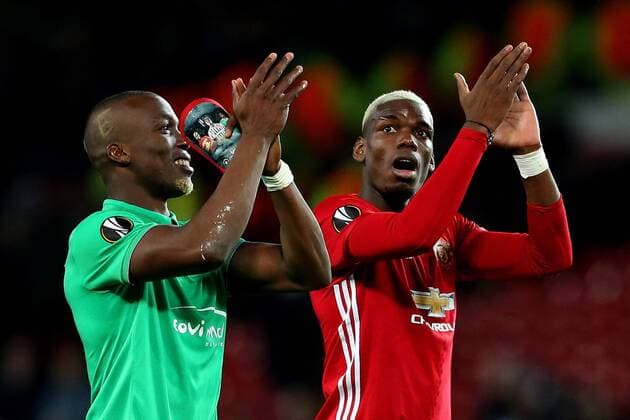 Florentin Pogba of Saint Etienne holds personalised shin pads as he applauds the crowd with brother Paul Pogba during the UEFA Europa League Round of 32 1st leg match at Old Trafford Stadium, Manchester. Picture date: February 16th, 2017. Pic credit should read: Matt McNulty Sportimage EDITORIAL USE ONLY. No use with unauthorised audio, video, data, fixture lists, club league logos or live services. Online in-match use limited to 120 images, no video emulation. No use in betting, games or single club league player publications.