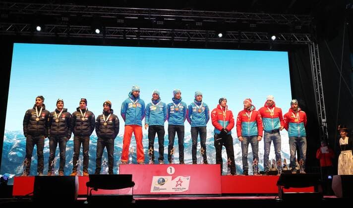 HOCHFILZEN, AUSTRIA - FEBRUARY 18, 2017: Silver medallists Martin Fourcade, Simon Desthieux, Quentin Fillon Maillet, and Jean Guillaume Beatrix of France, gold medallists Anton Shipulin, Anton Babikov, Maxim Tsvetkov, and Alexei Volkov of Russia, bronze medallists Dominik Landertinger, Simon Eder, Julian Eberhard, Daniel Mesotitsch of Austria, from left, pose at a victory ceremony for the men s 4x7.5km relay at the 2017 IBU Biathlon World Championships in Hochfilzen, Austria. Stanislav Krasilnikov TASS TS041D22