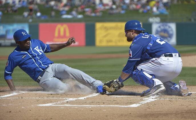 February 25, 2017 - Surprise, AZ, USA - The Kansas City Royals Lorenzo Cain, left, is tagged out at home plate by Texas Rangers catcher Jonathan Lucroy during the first inning in a spring training game in Surprise, Ariz., on Saturday, Feb. 25, 2017. The Royals won, 7-5. Texas Rangers spring training - ZUMAm67_ 20170225_zaf_m67_076 Copyright: xMaxxFaulknerx