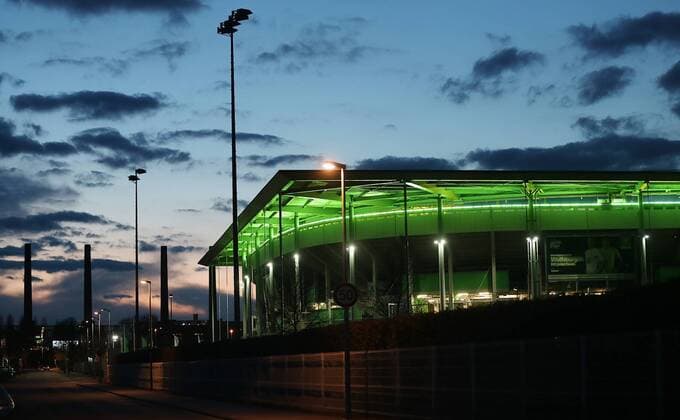 Volkswagenarena bei Nacht, im Hintergrund die Tuerme des VW Heizkraftwerkes